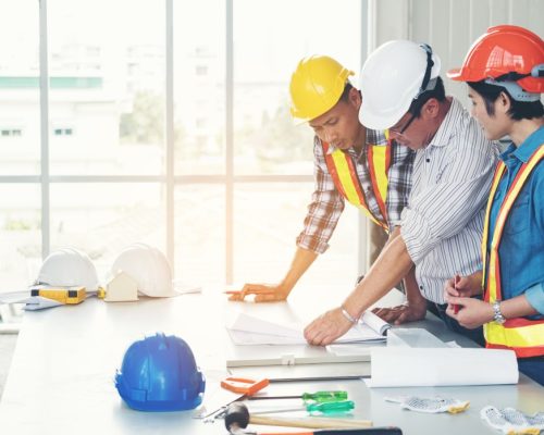 group-engineers-and-architects-are-discussing-the-construction-helmet-blueprint-for-use-in_t20_Gg98N0