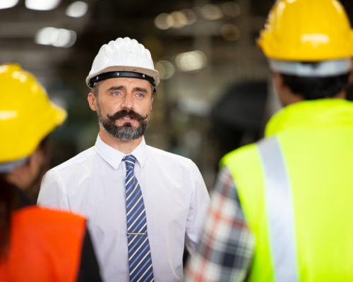 group-of-workers-change-of-workers-in-the-factory-people-go-in-helmets-and-uniforms-for-an-industrial_t20_7yeJOj